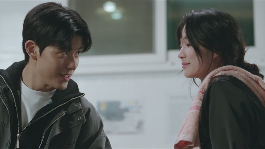 Kim Hye-yoon com sorriso astuto encarando Lomon.