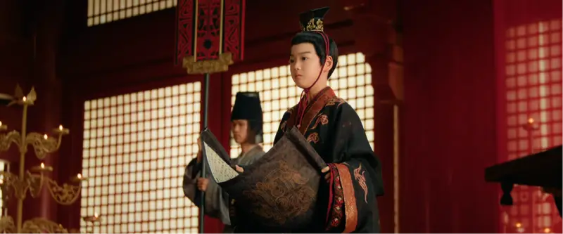 O jovem imperador Xiao Yu durante a leitura do decreto no salão principal do império