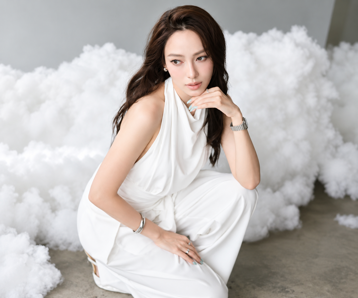 Pear Pitchapa seated in a white outfit